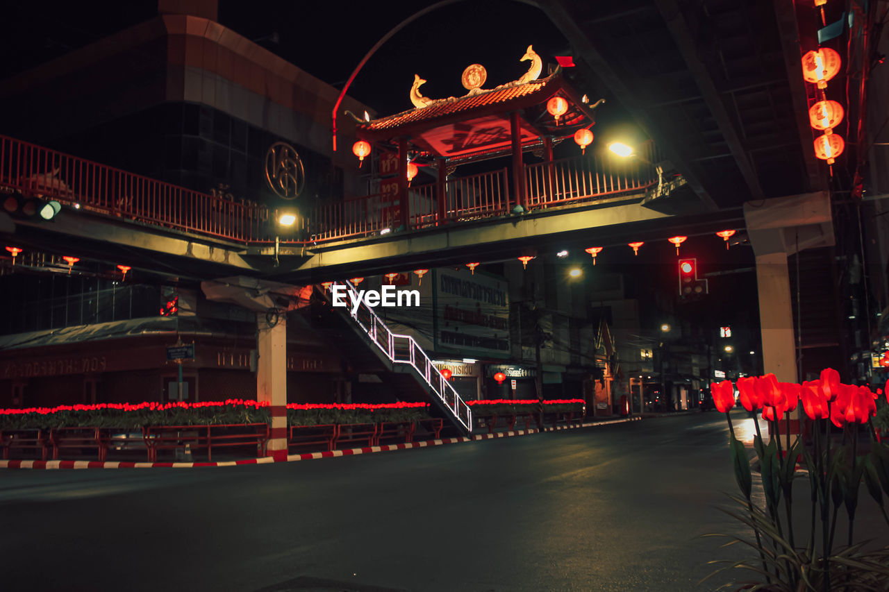 Illuminated bridge over city at night