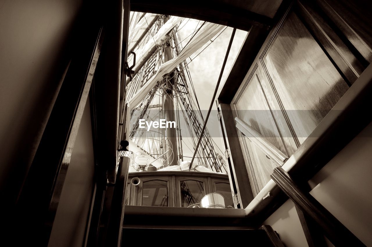 Low angle view of sailing vessel seen through down stairs