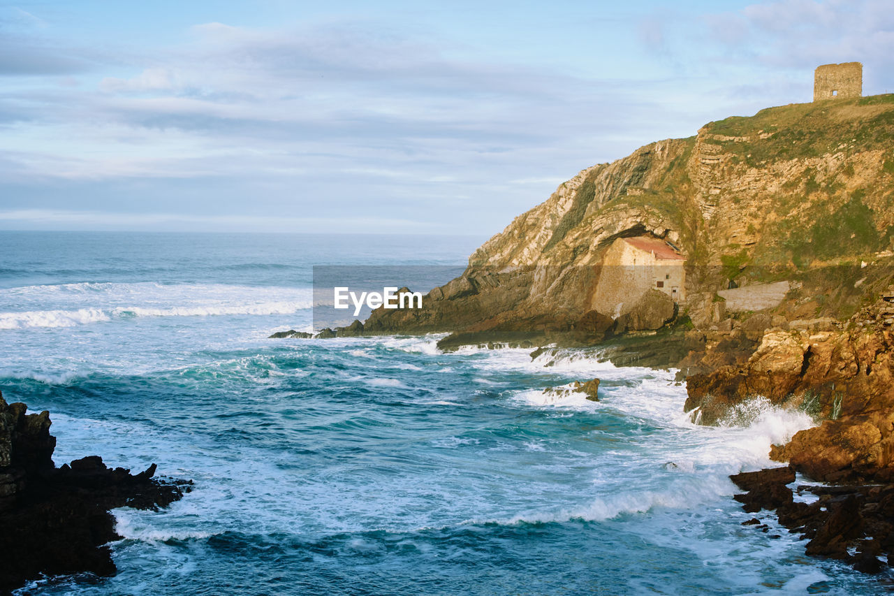 SCENIC VIEW OF SEA AGAINST ROCK FORMATION