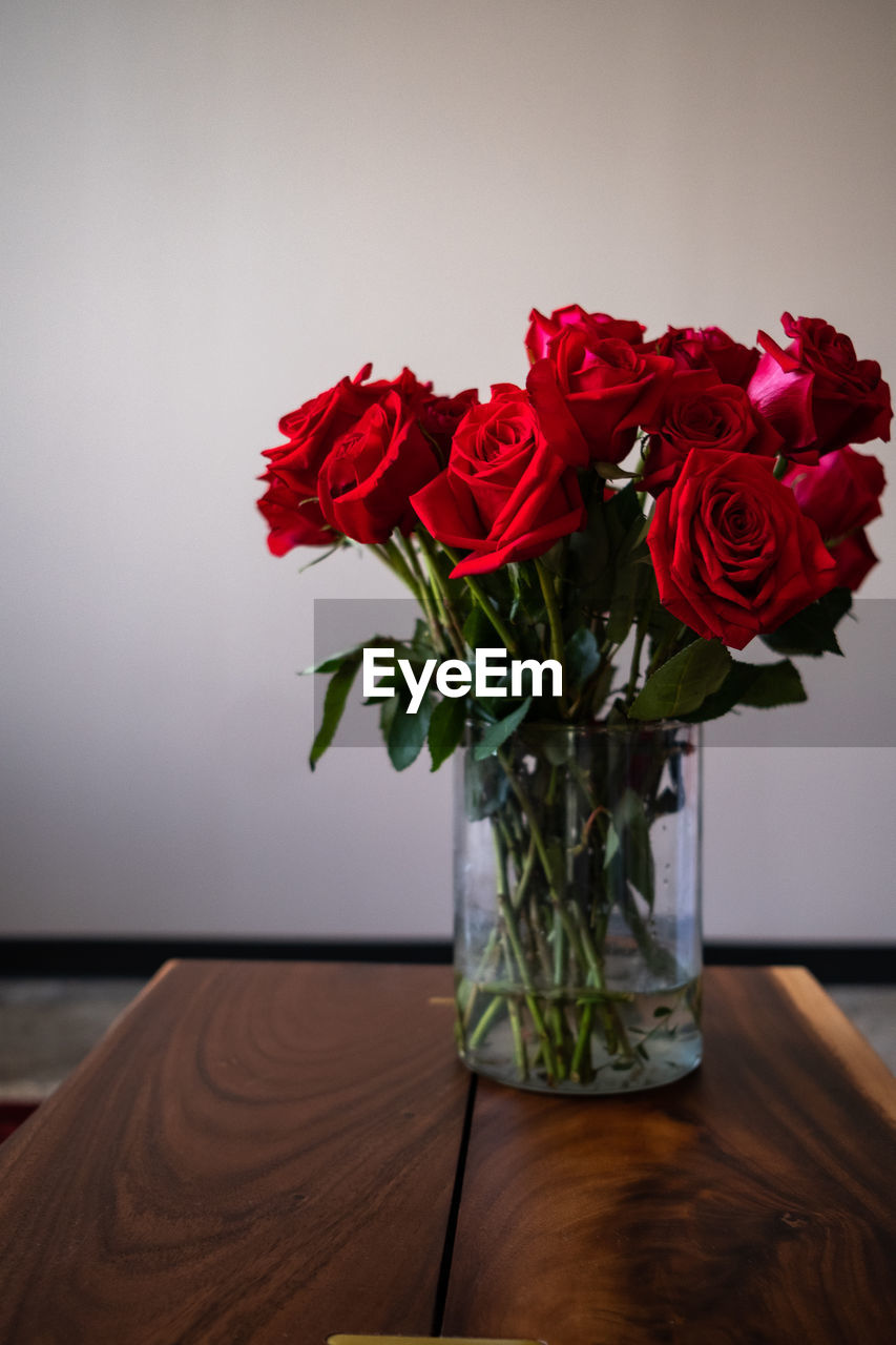 Close-up of red roses in vase on table