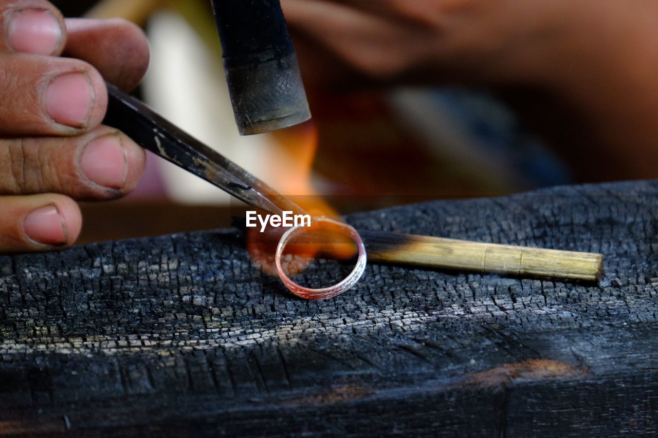 Cropped image of jeweller making ring 