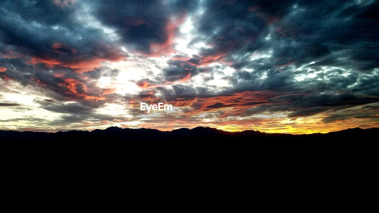 SILHOUETTE LANDSCAPE AGAINST DRAMATIC SKY