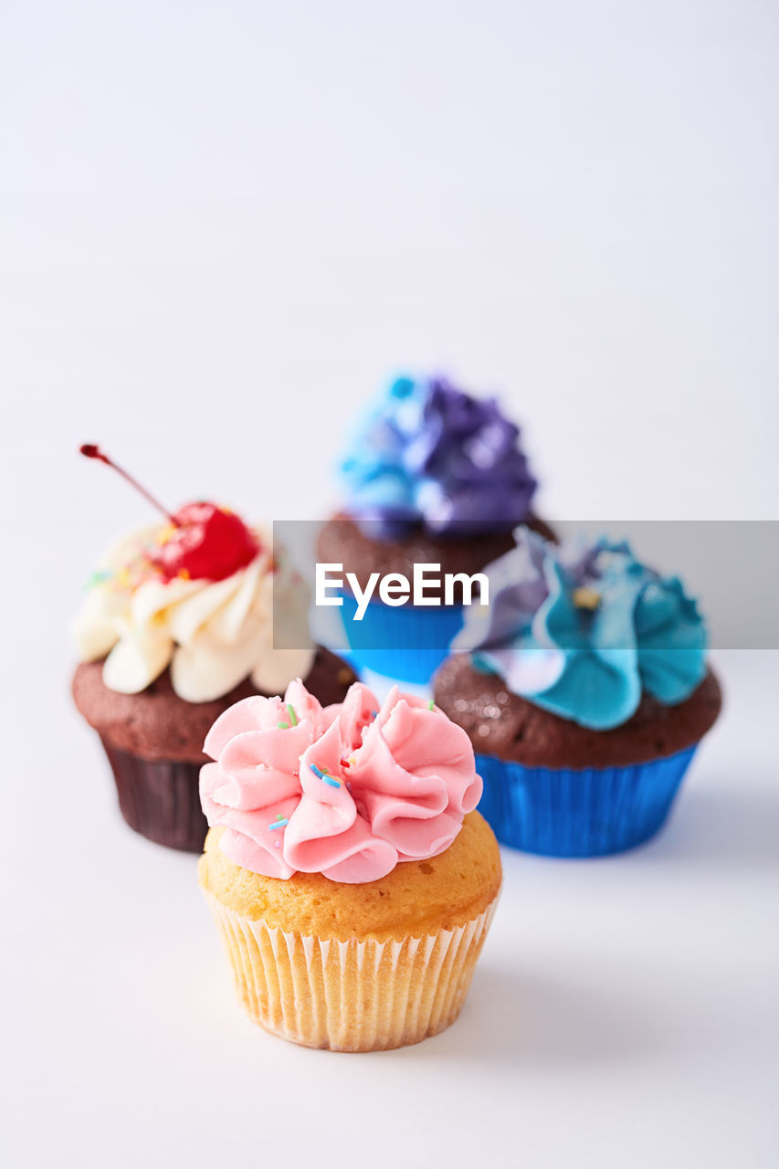 Close-up of cupcakes against white background