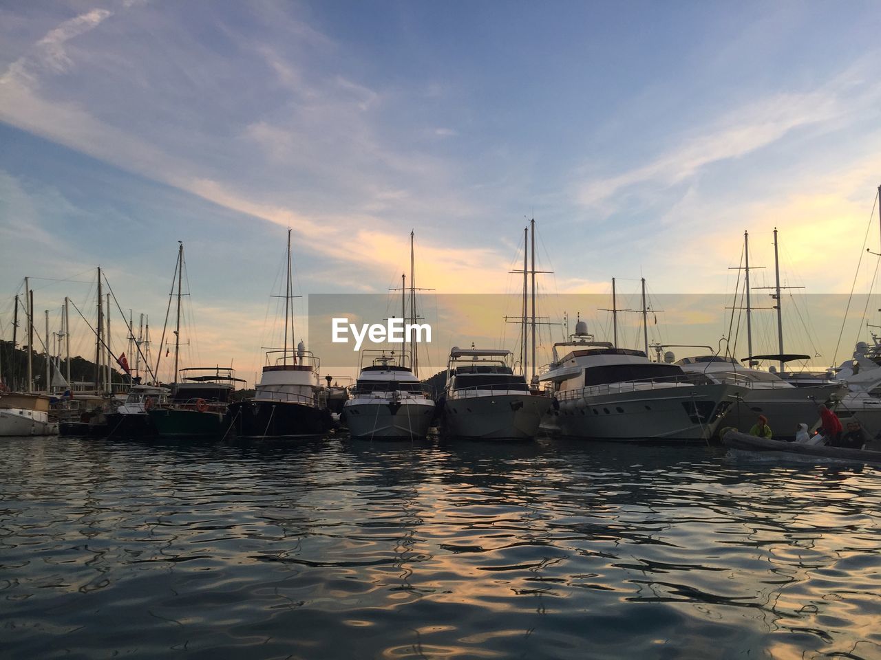 BOATS MOORED AT HARBOR