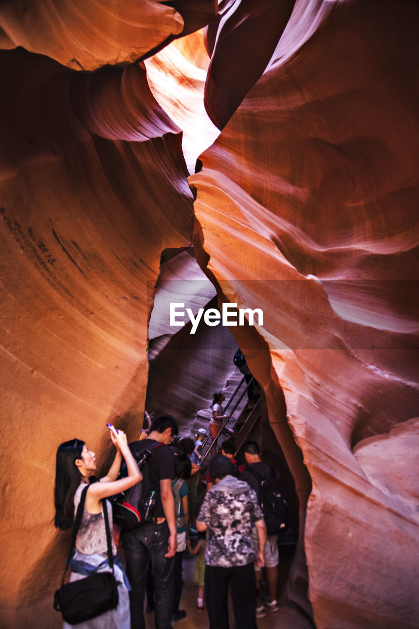 People walking amidst rock formations