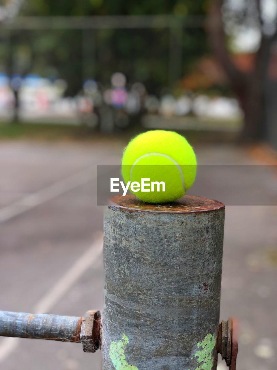 Tennis ball balanced on the net post