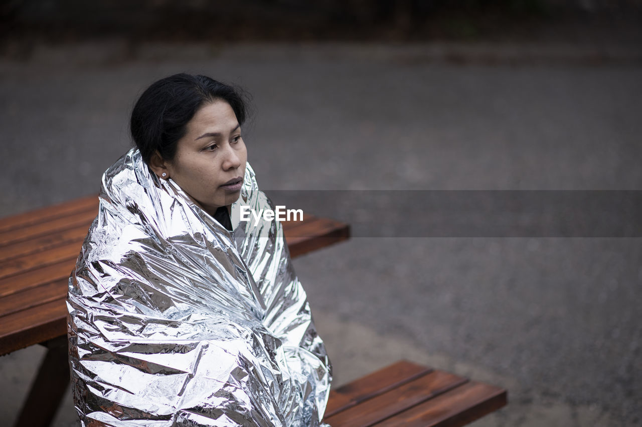 Woman wrapped in emergency blanket