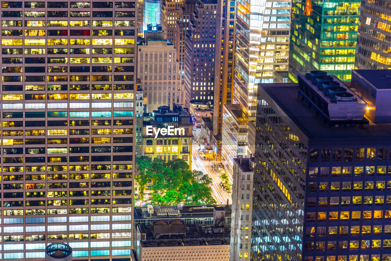 illuminated buildings in city at dusk