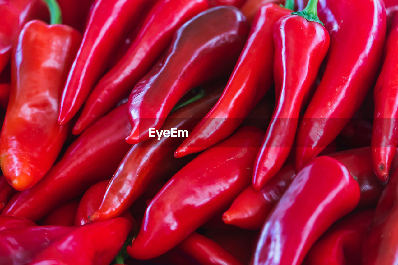 full frame shot of red chili peppers for sale at market