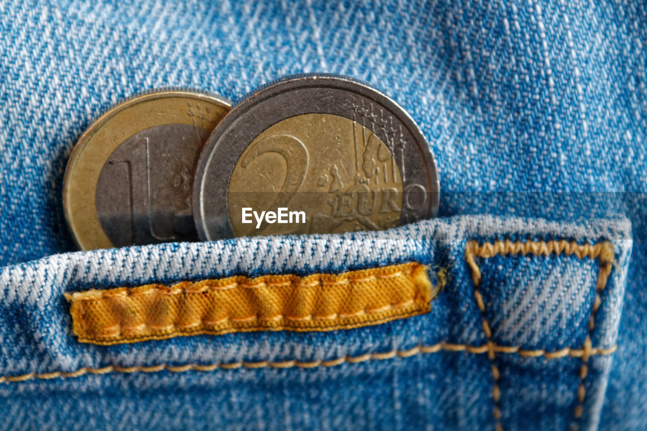 Close-up of coins in back pocket of jeans