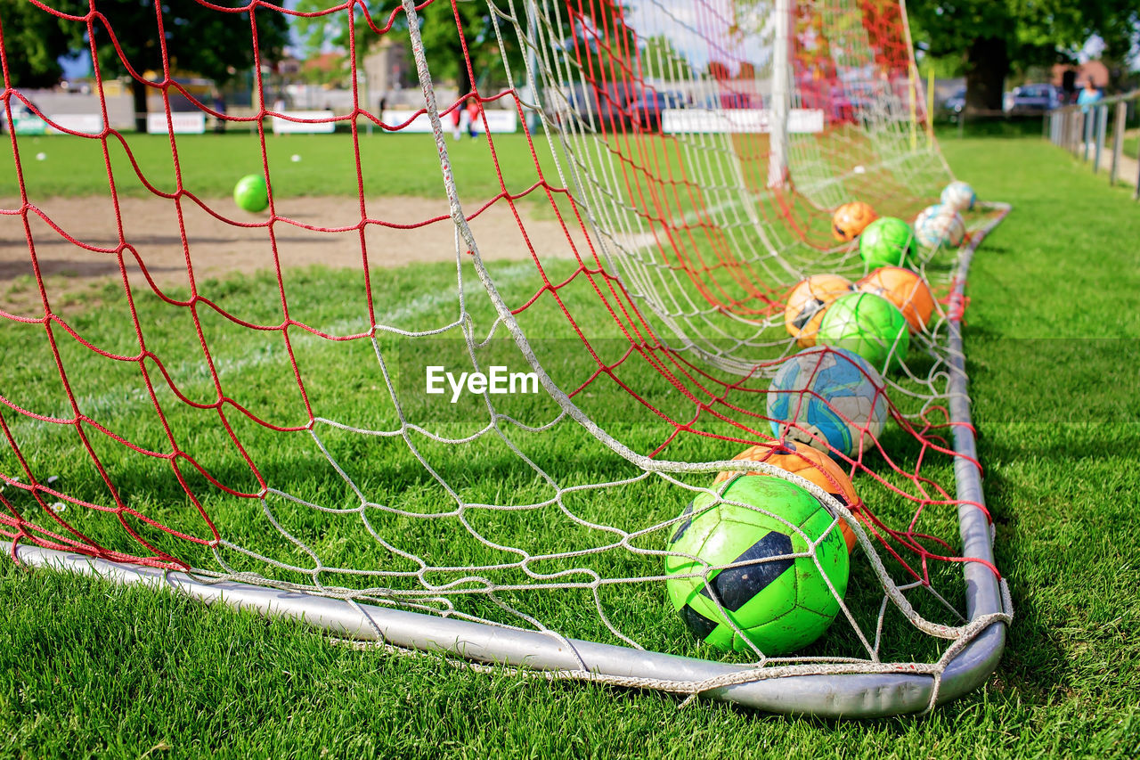 grass, plant, sports, player, playground, nature, green, day, net - sports equipment, soccer, childhood, team sport, lawn, soccer field, outdoors, net, sports equipment, outdoor play equipment, field, child, leisure activity, men