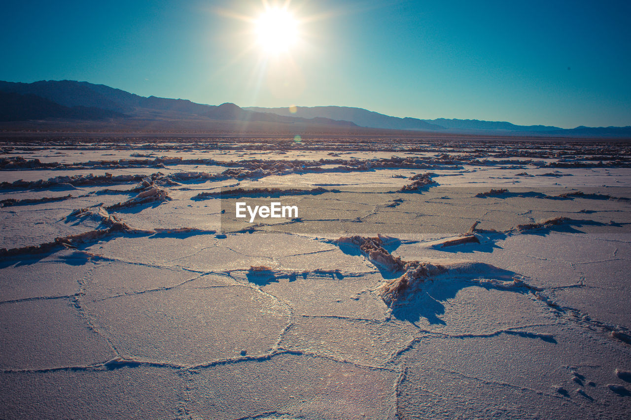 Scenic view of salt desert against clear bright sky