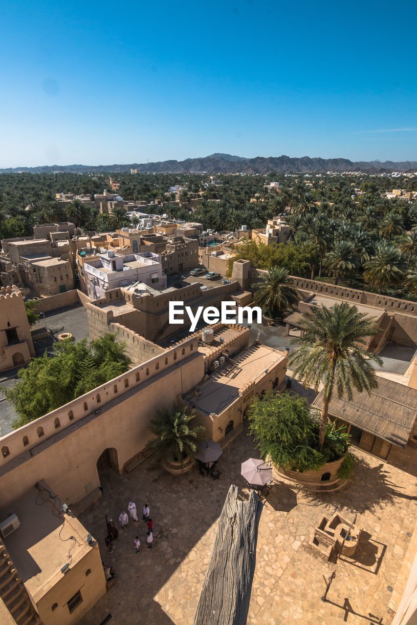 High angle view of townscape against blue sky