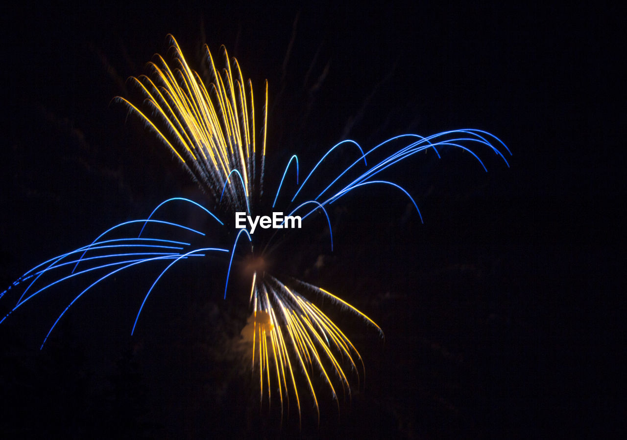 Low angle view of firework display at night