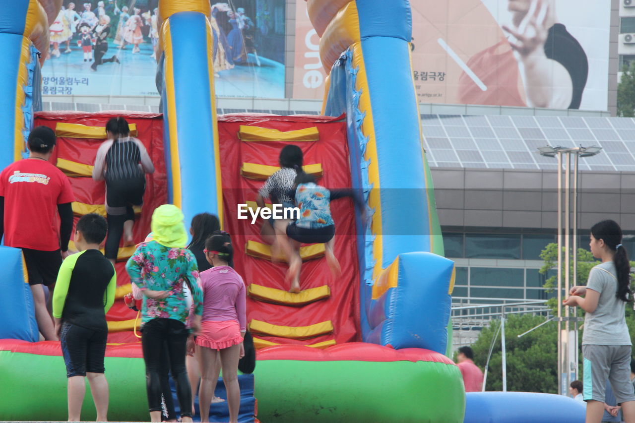 GROUP OF PEOPLE IN AMUSEMENT PARK RIDE