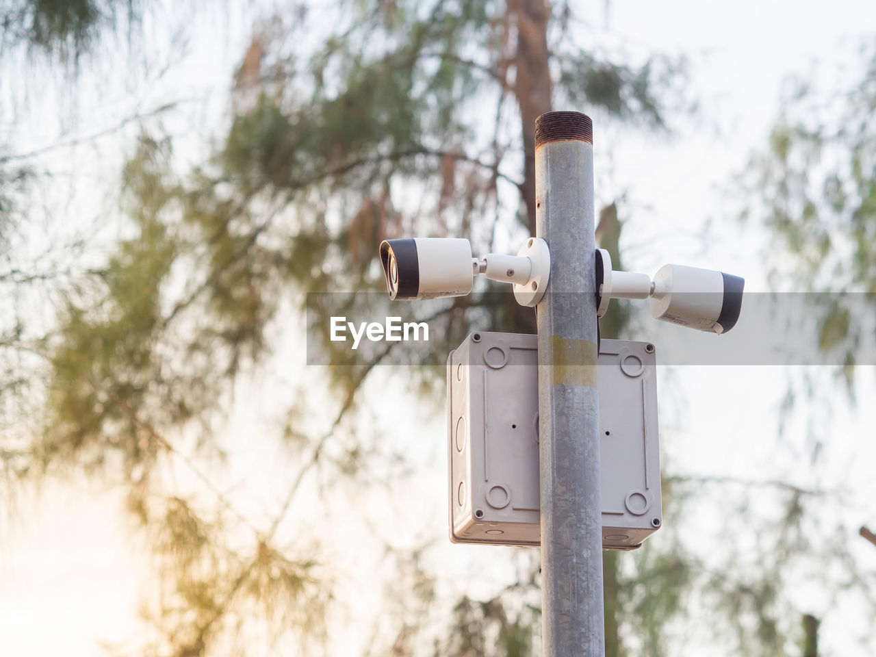 Low angle view of security cameras against sky