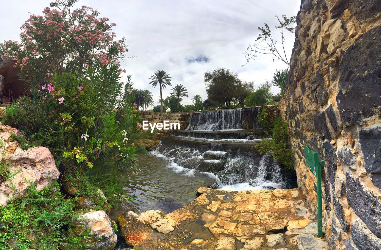 Scenic view of waterfall against sky