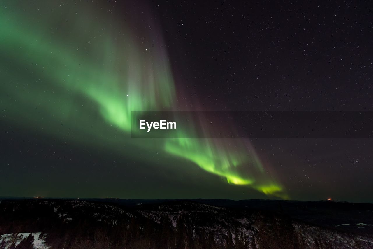 Scenic view of landscape against sky at night