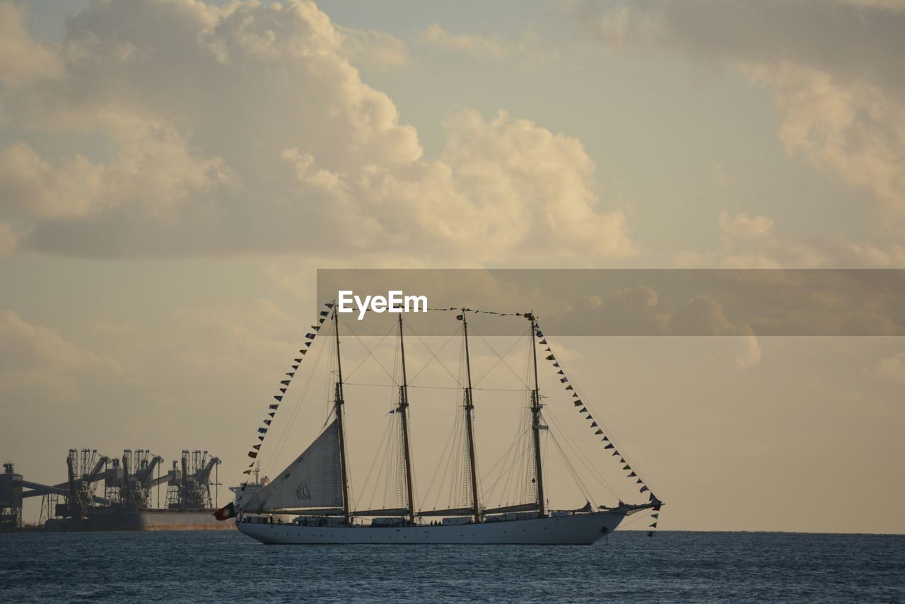 NAUTICAL VESSEL SAILING ON SEA AGAINST SKY