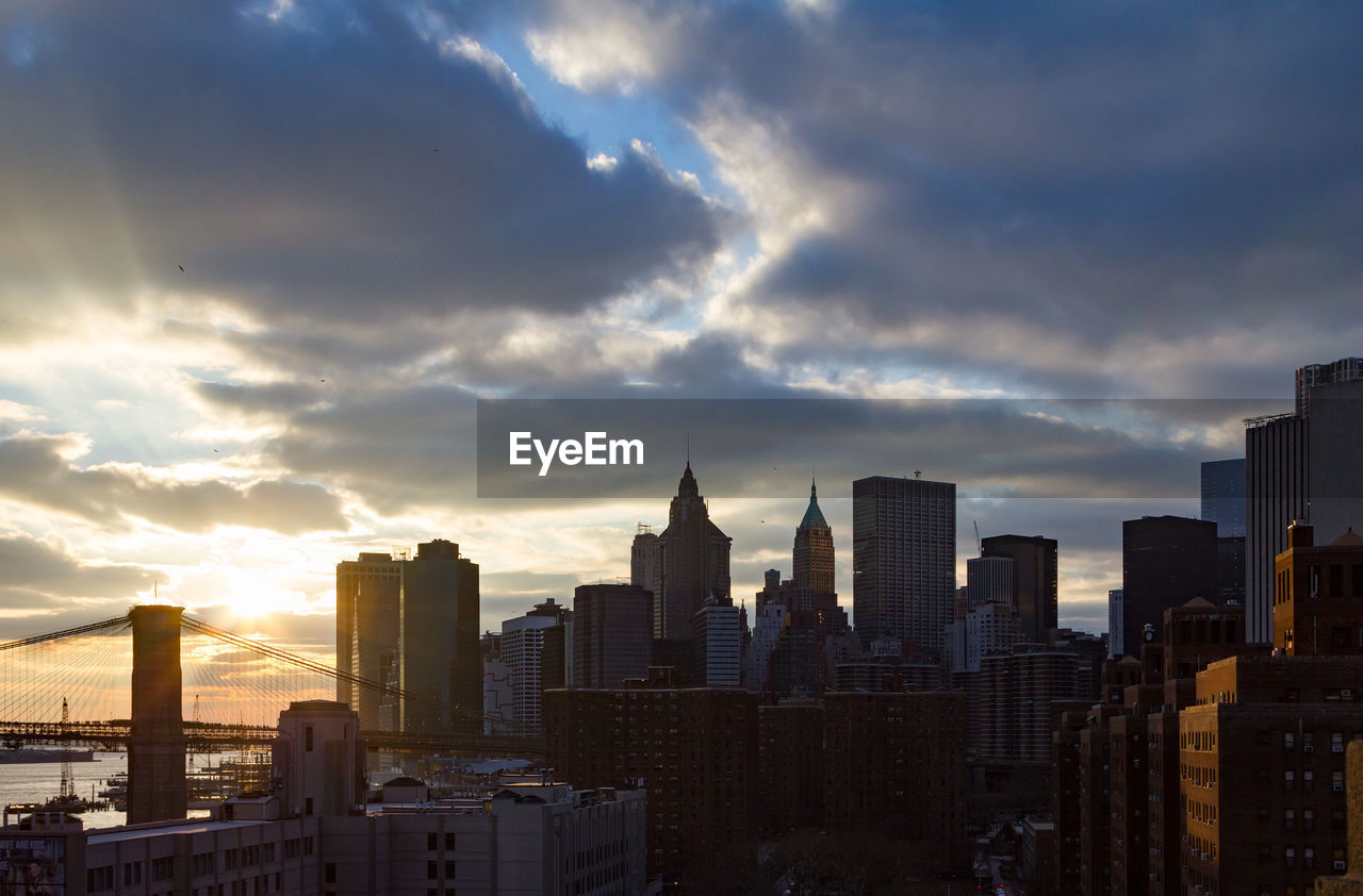 VIEW OF BUILDINGS AGAINST CLOUDY SKY