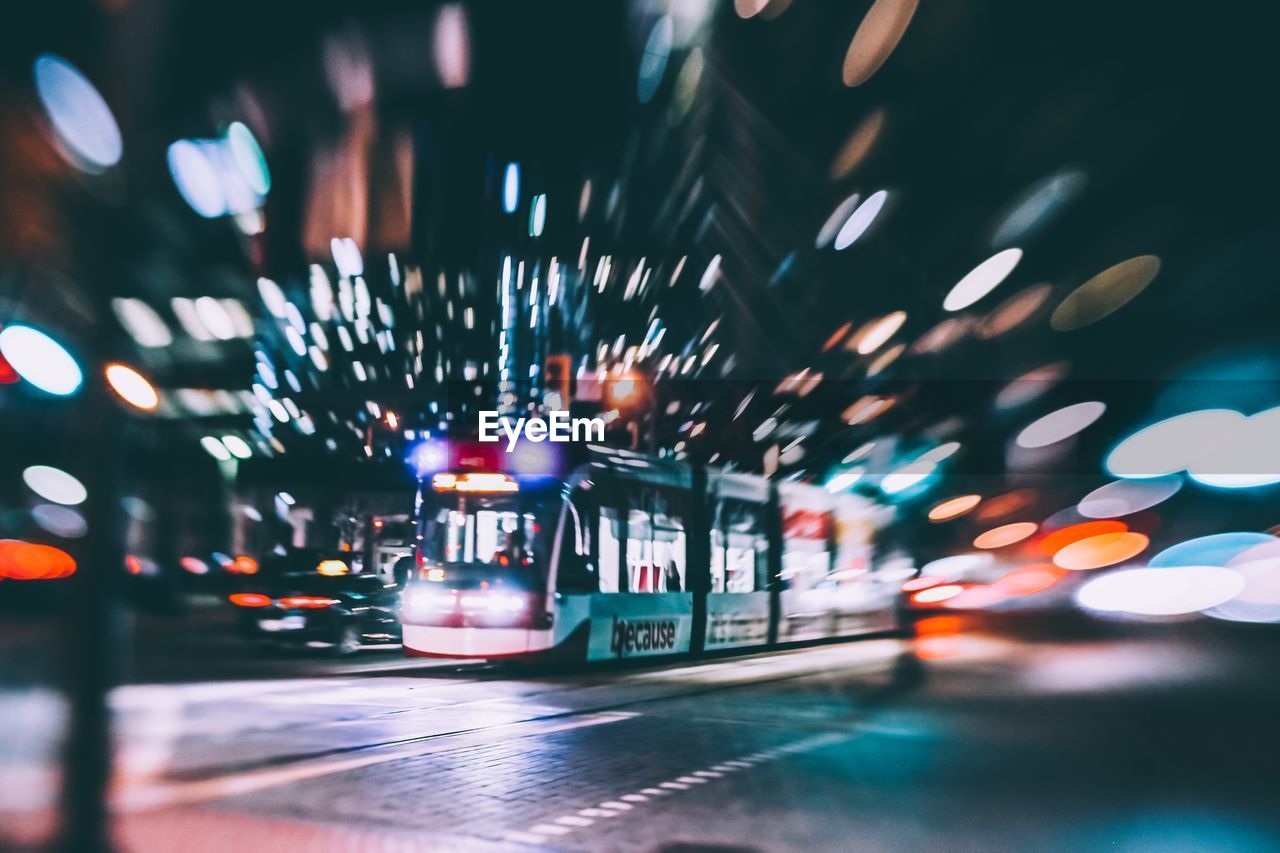 BLURRED MOTION OF ILLUMINATED CAR ON STREET