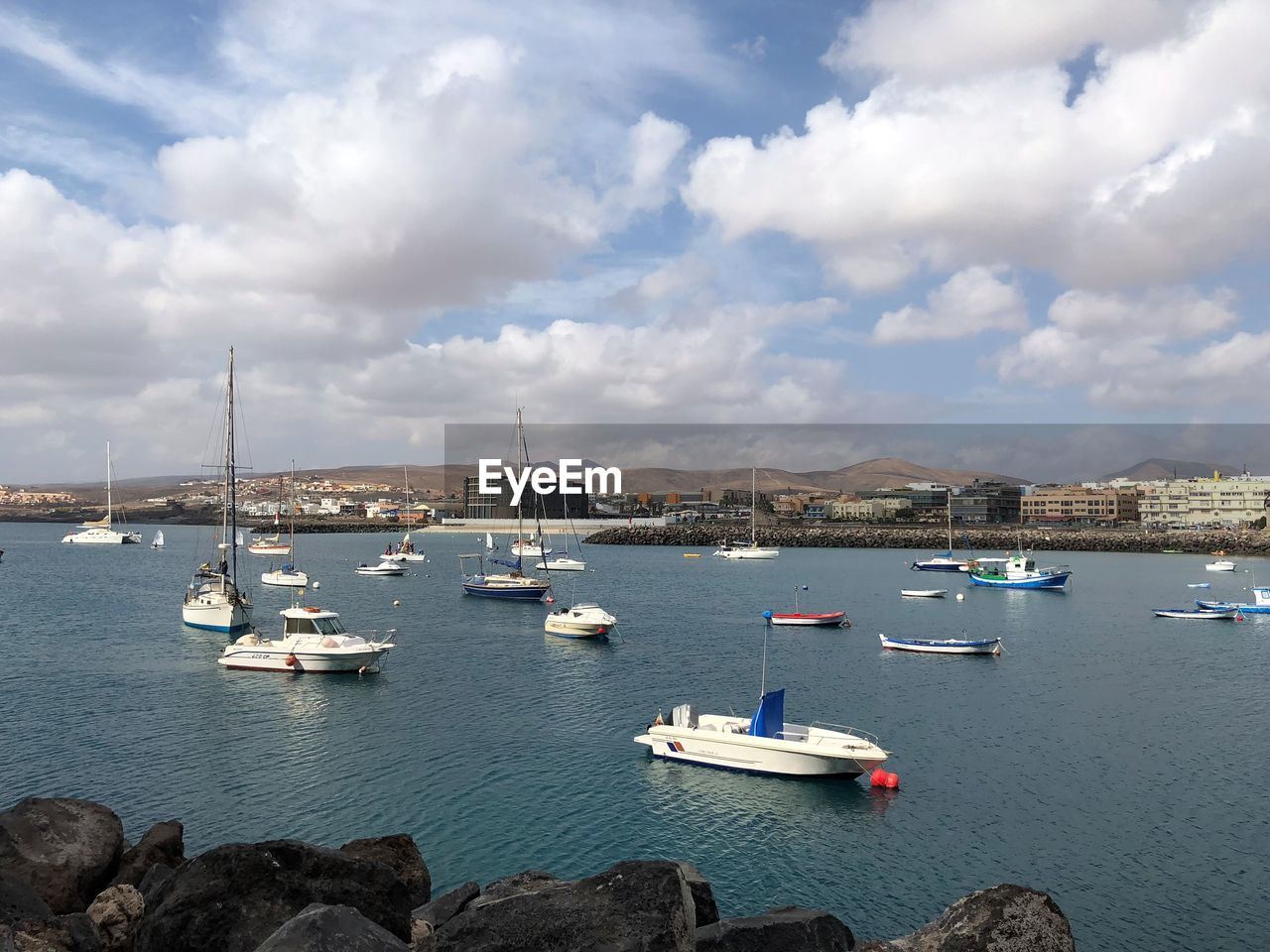 Sailboats moored in harbor