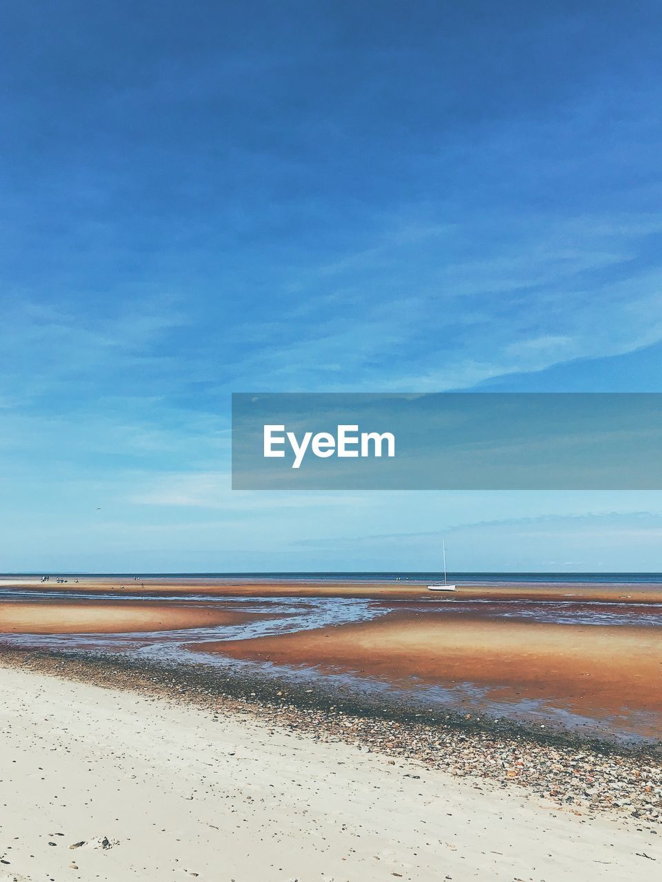 Scenic view of beach against blue sky