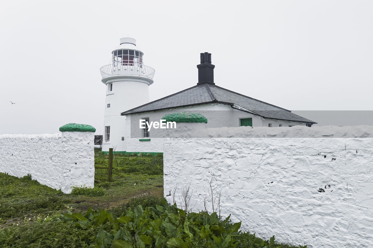 LIGHTHOUSE AGAINST CLEAR SKY