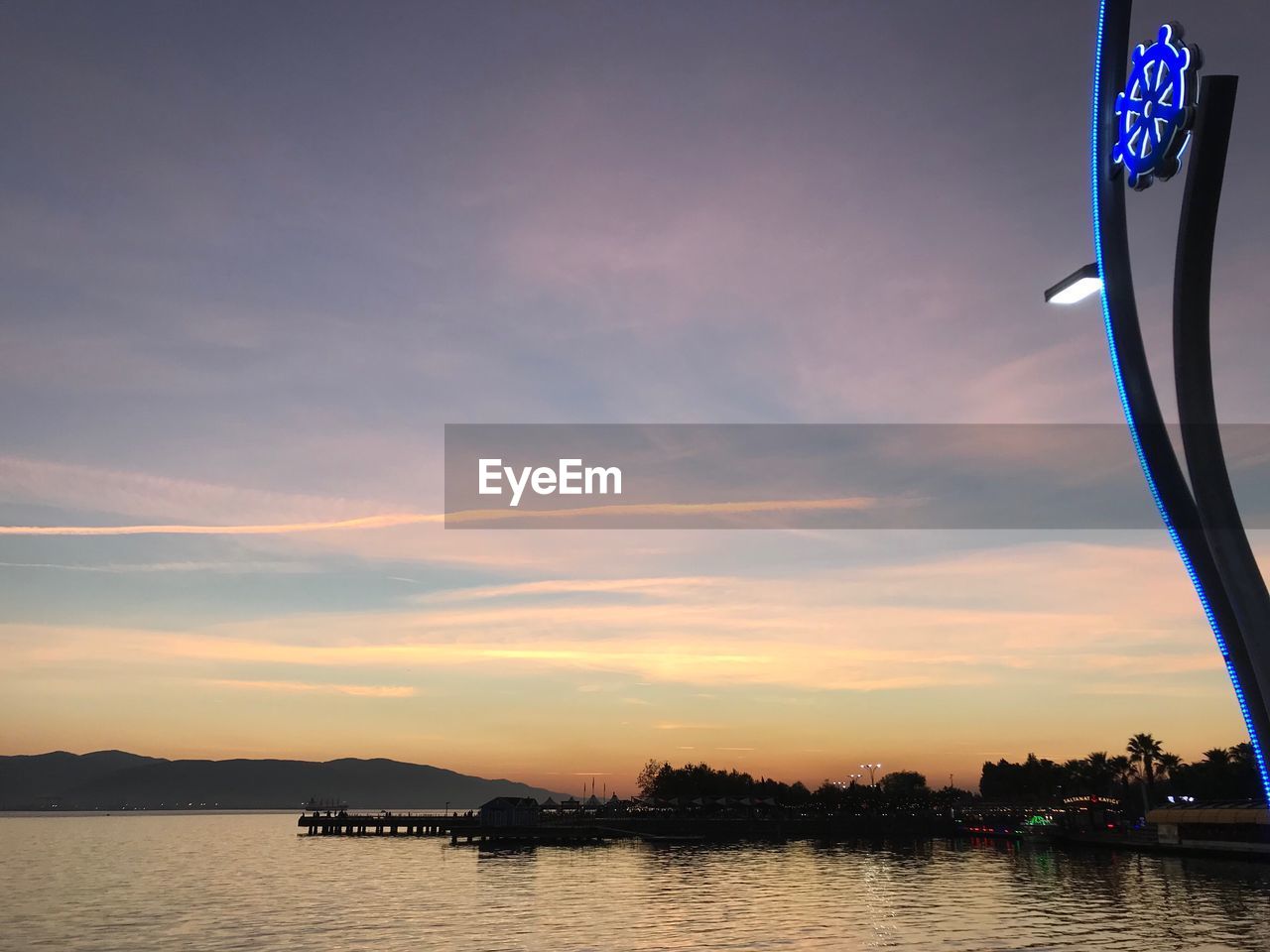 Scenic view of river against sky during sunset