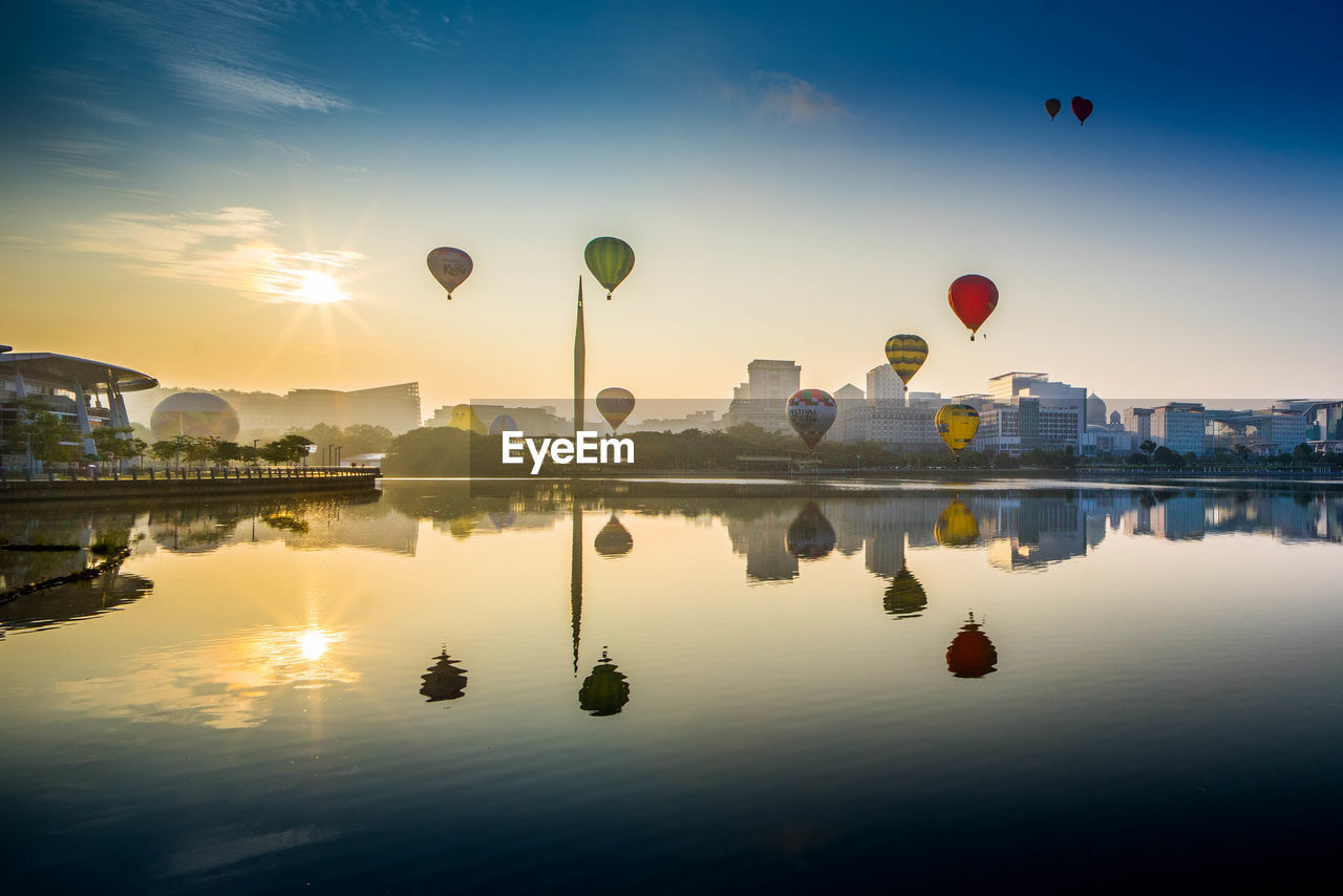 HOT AIR BALLOONS FLYING OVER WATER