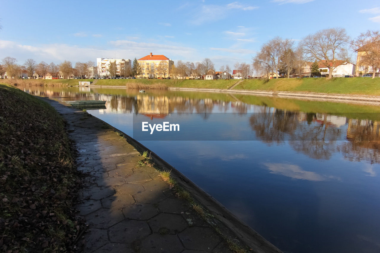 reflection, water, architecture, built structure, river, sky, building exterior, waterway, nature, building, tree, plant, house, city, autumn, cloud, travel destinations, body of water, reservoir, no people, pond, environment, residential district, landscape, outdoors, beauty in nature, morning, travel, history, tourism, blue, day, scenics - nature, tranquility, the past, mansion