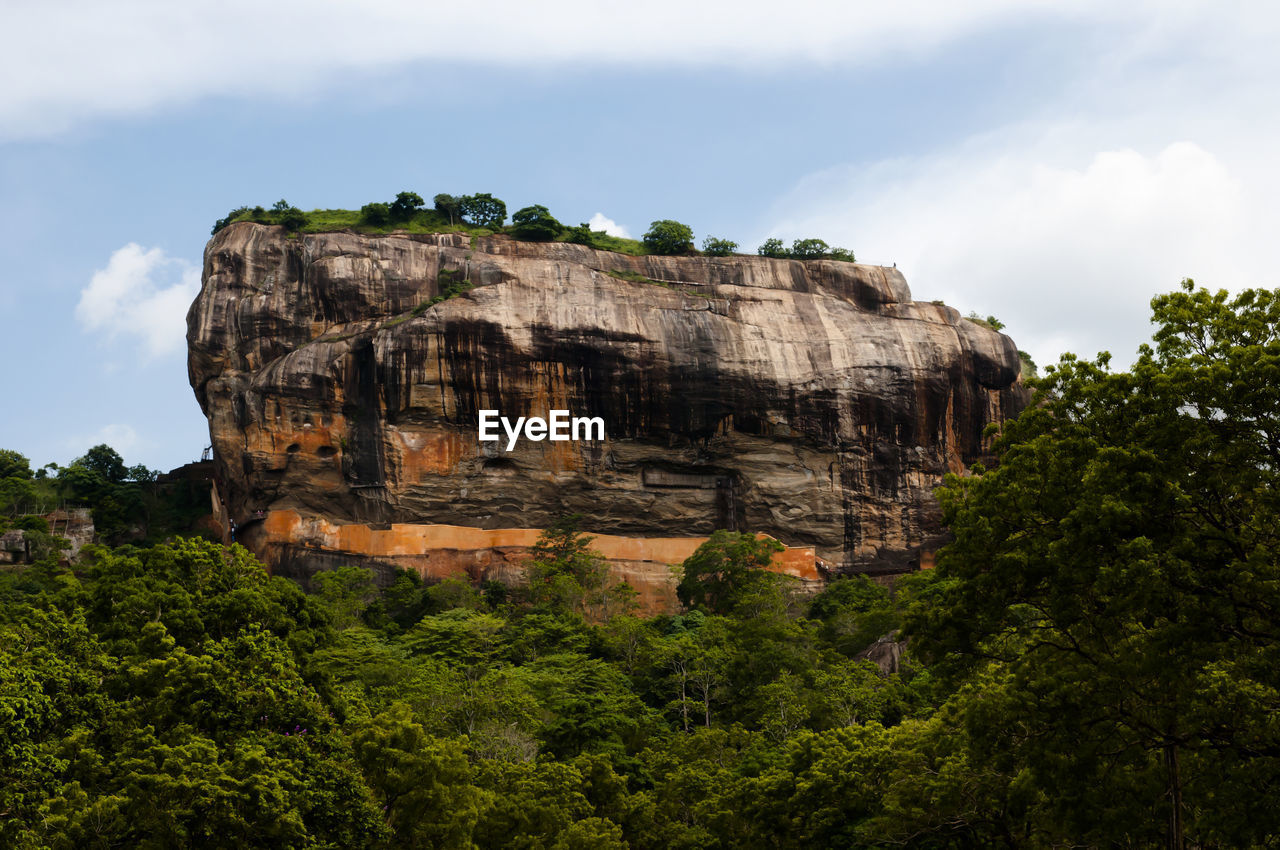 Low angle view of rock formation against sky