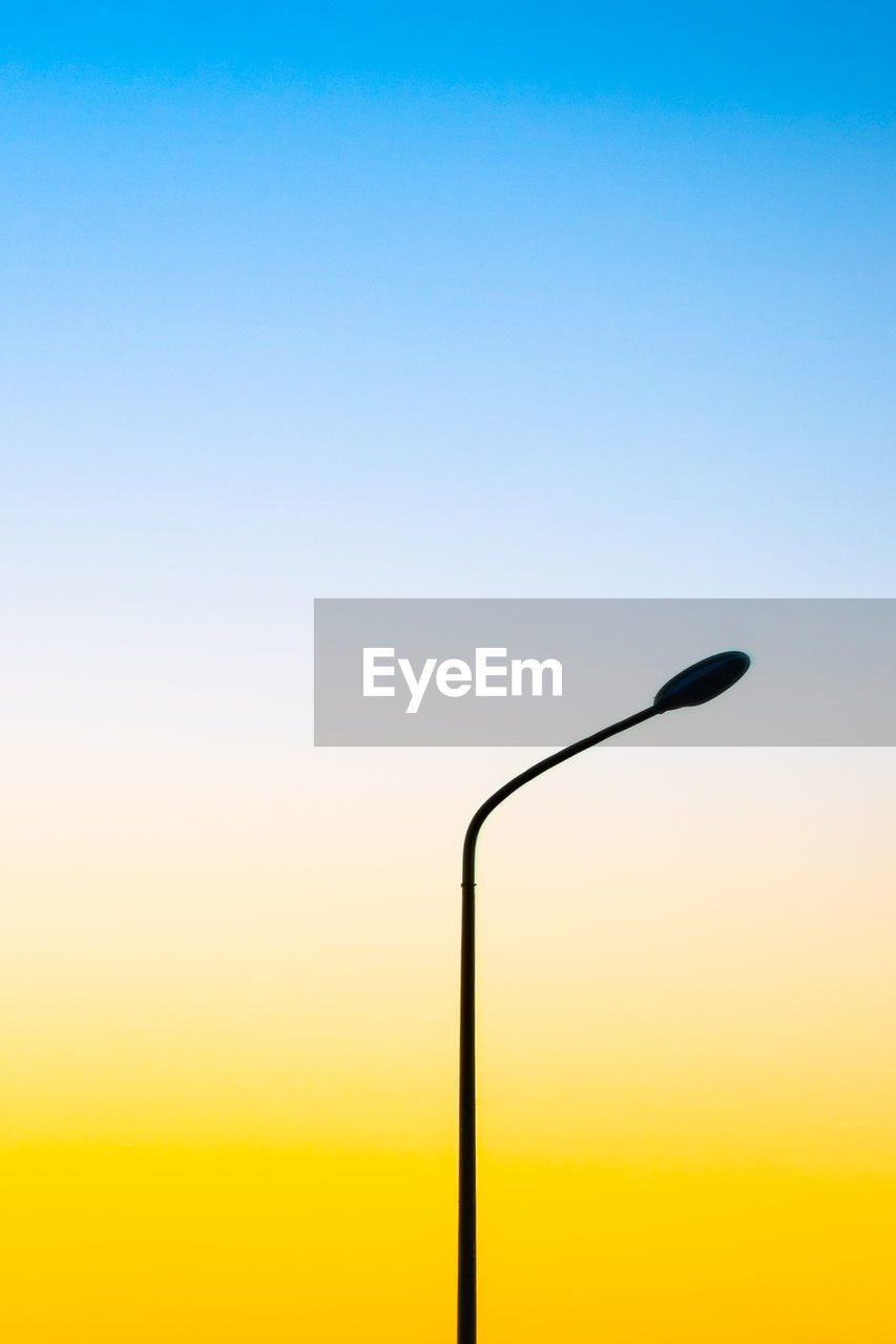 Silhouette street light against clear sky during sunset