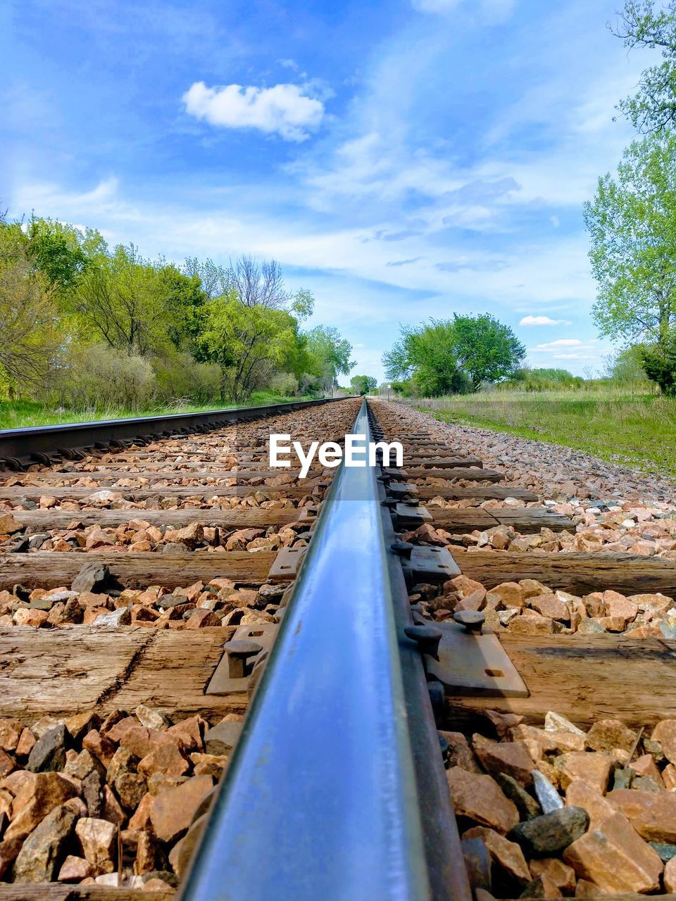 Surface level of railroad tracks against sky