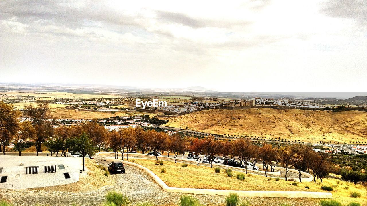 PANORAMIC SHOT OF ROAD BY LANDSCAPE AGAINST SKY