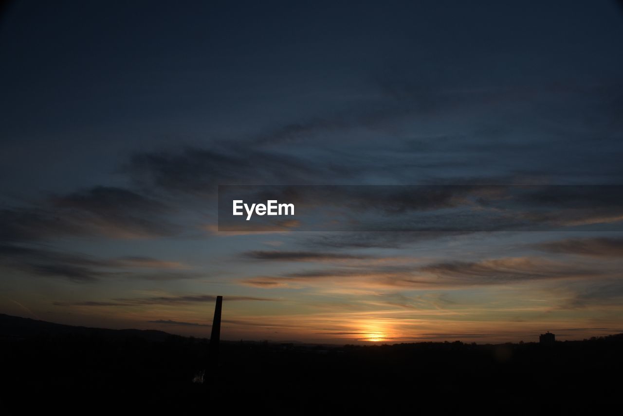 LOW ANGLE VIEW OF DRAMATIC SKY OVER SILHOUETTE LANDSCAPE