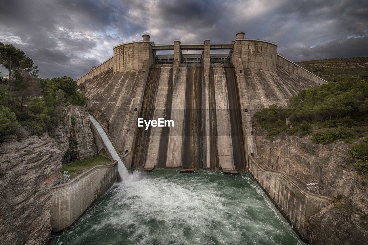 View of dam against cloudy sky