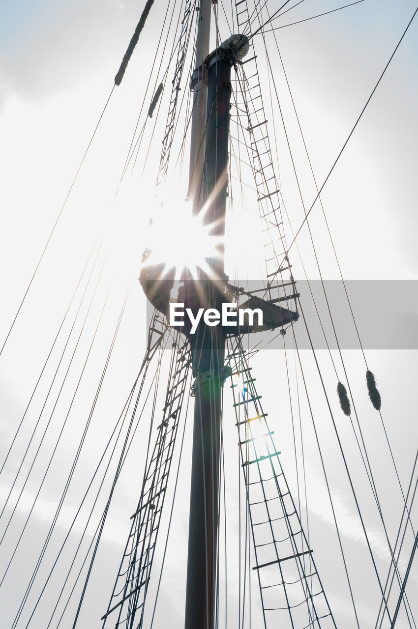 Low angle view of ship mast against sky