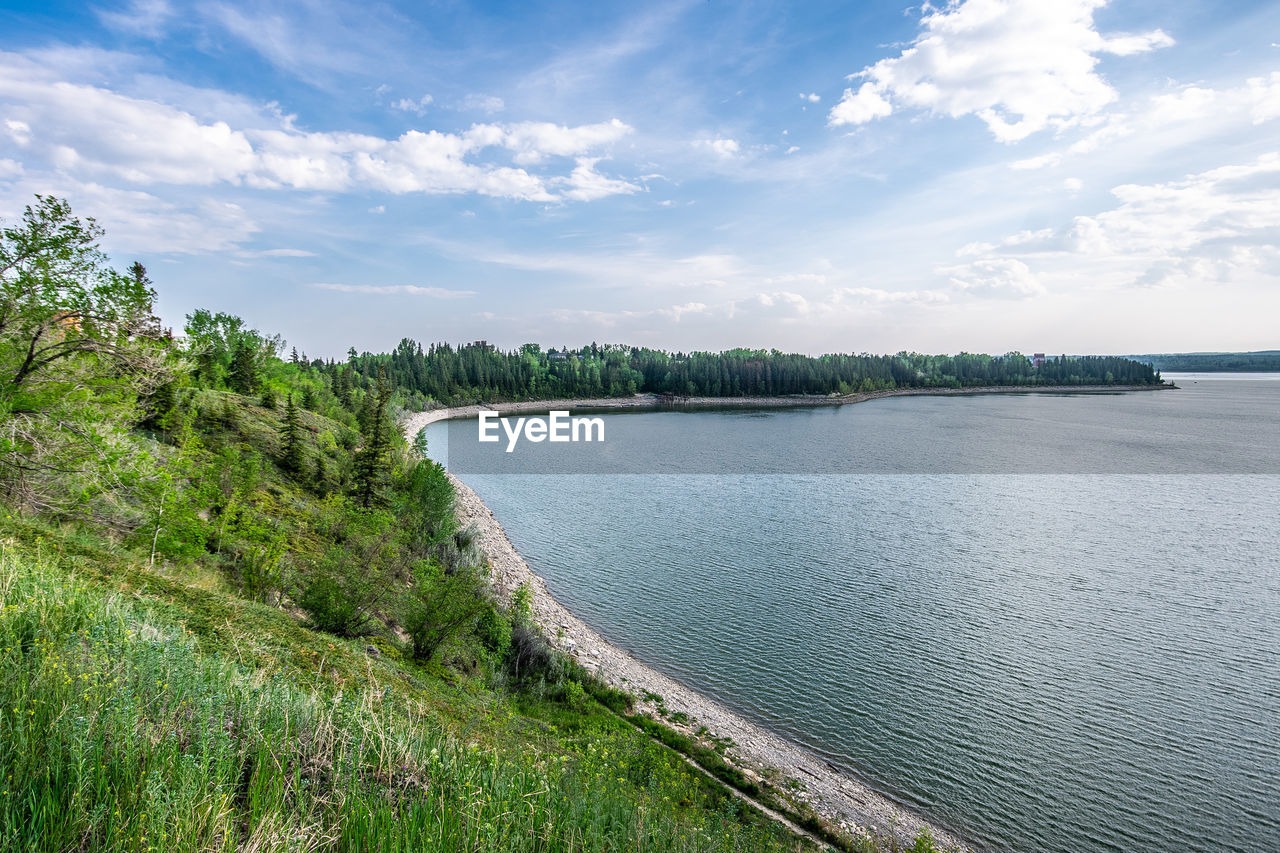 Summer scenic views of at lake against sky at the glenmore reservoir in calgary, alberta.