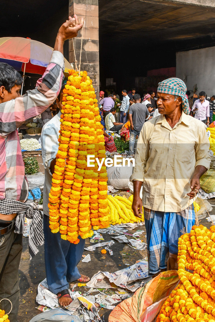 GROUP OF PEOPLE IN MARKET