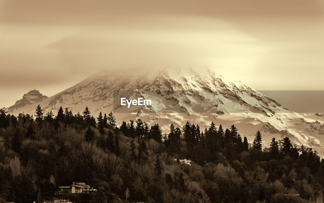 Clouds cover mount rainier across the puget sound in washington state.