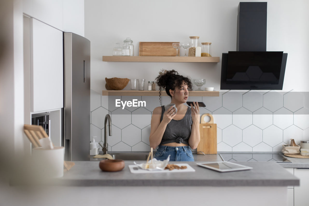 Woman sitting on table at home