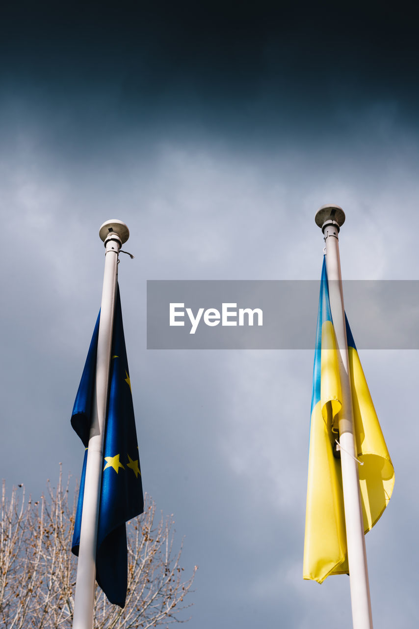 The flag of the european union and ukraine flutter in the wind