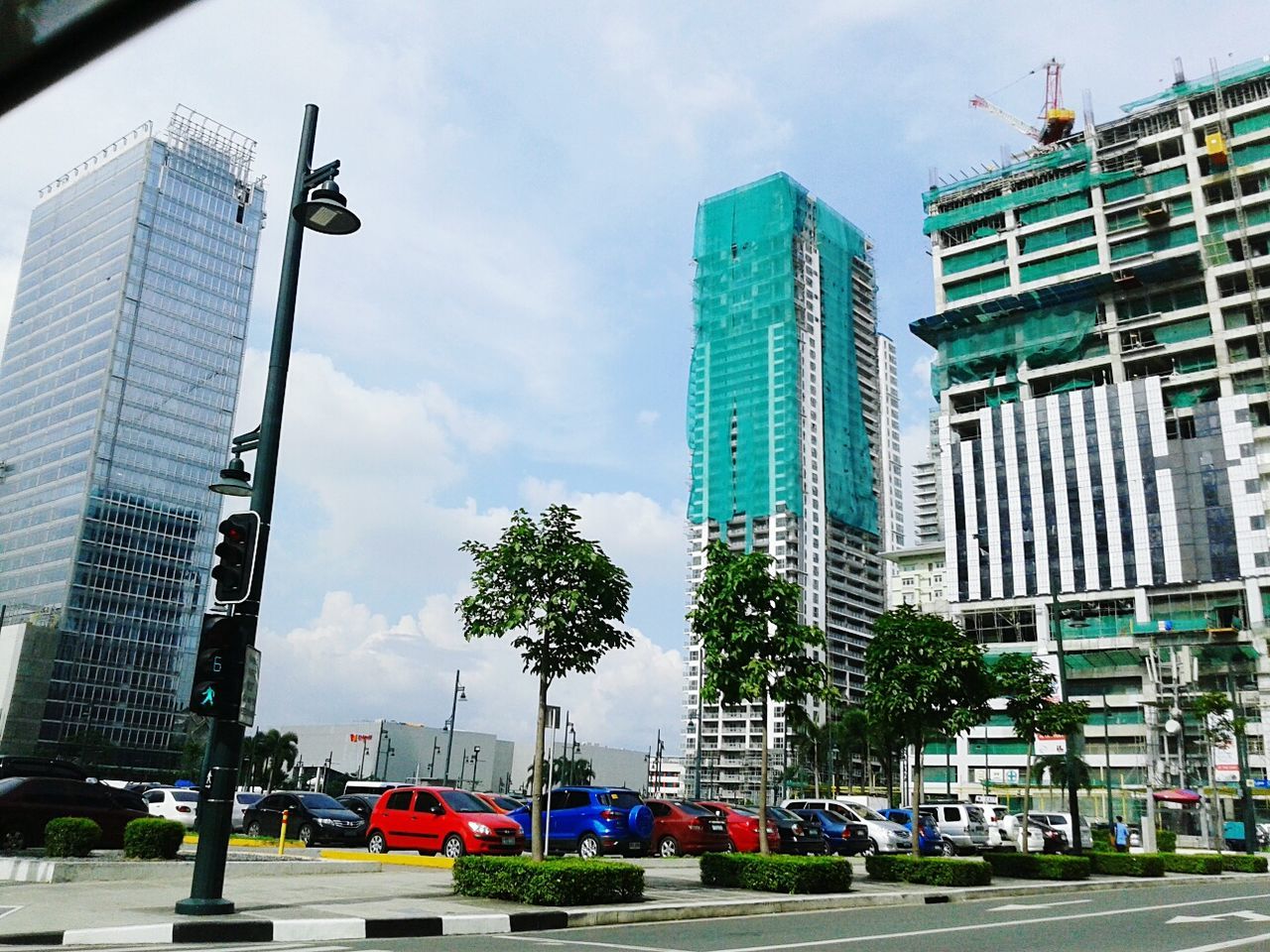 Cars in parking lot against buildings in city