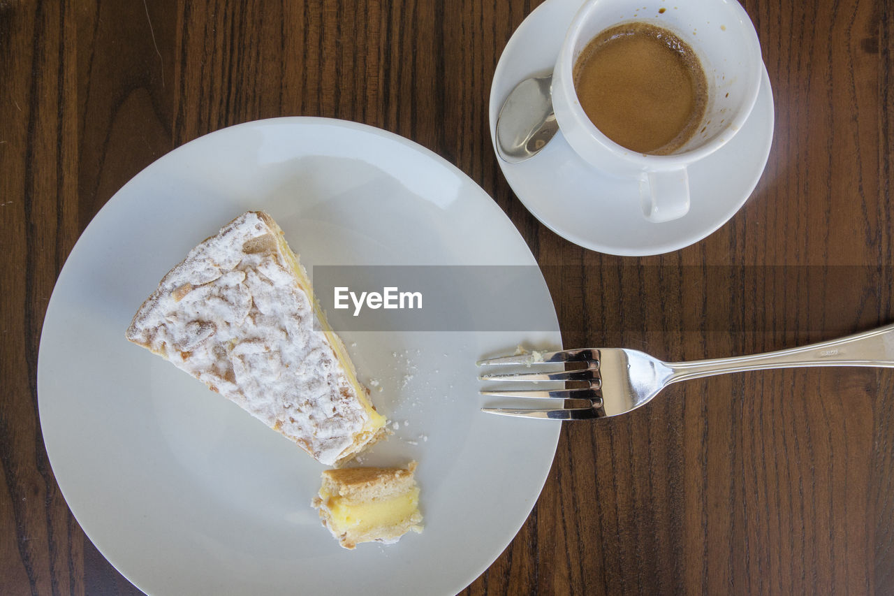 Above-view of a slice of italian custard cake and a cup of espresso