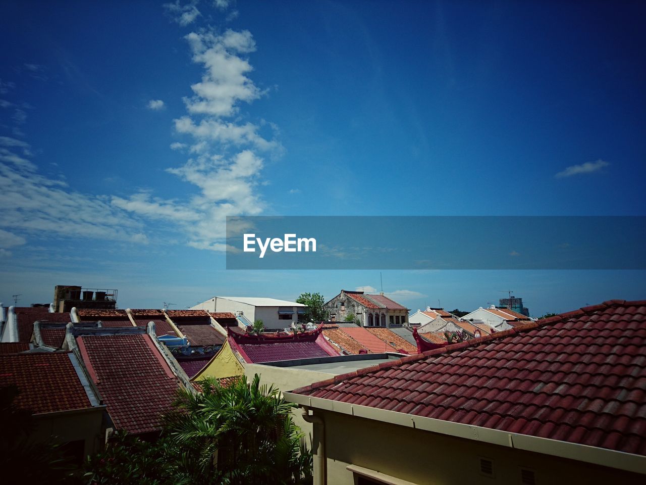 Houses against blue sky in city