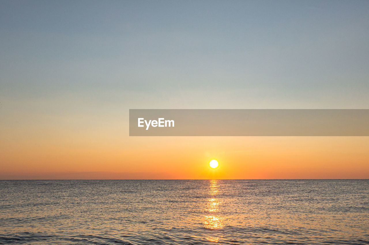 Sunrise on the sea with reflection on the water