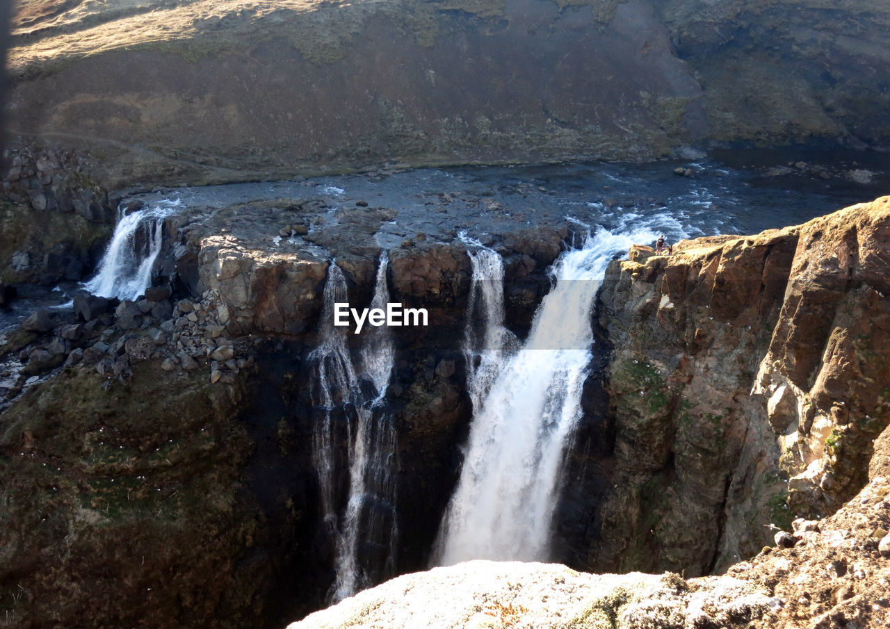 SCENIC VIEW OF WATERFALL IN SEA