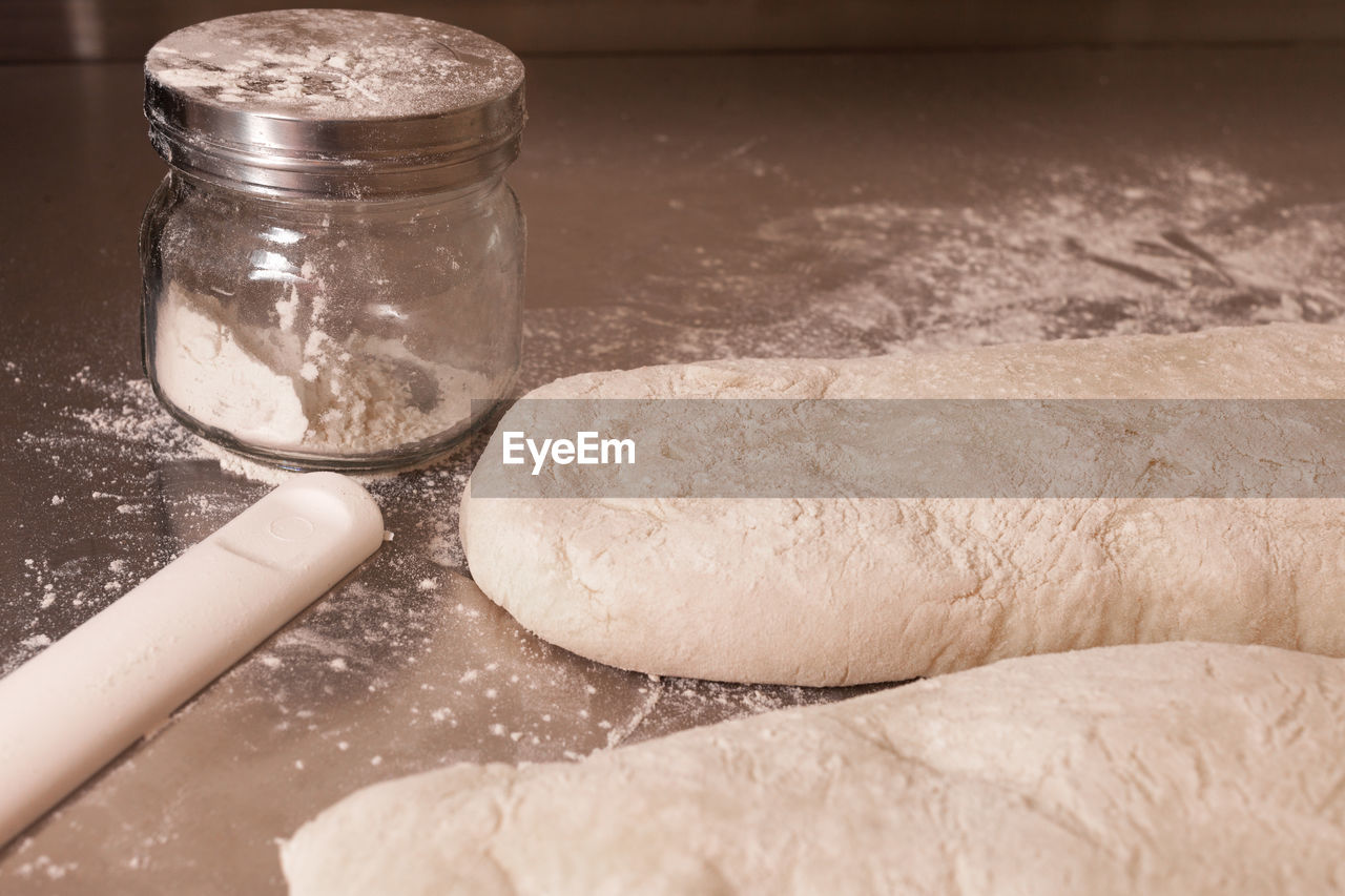 Close-up of dough and flour on table