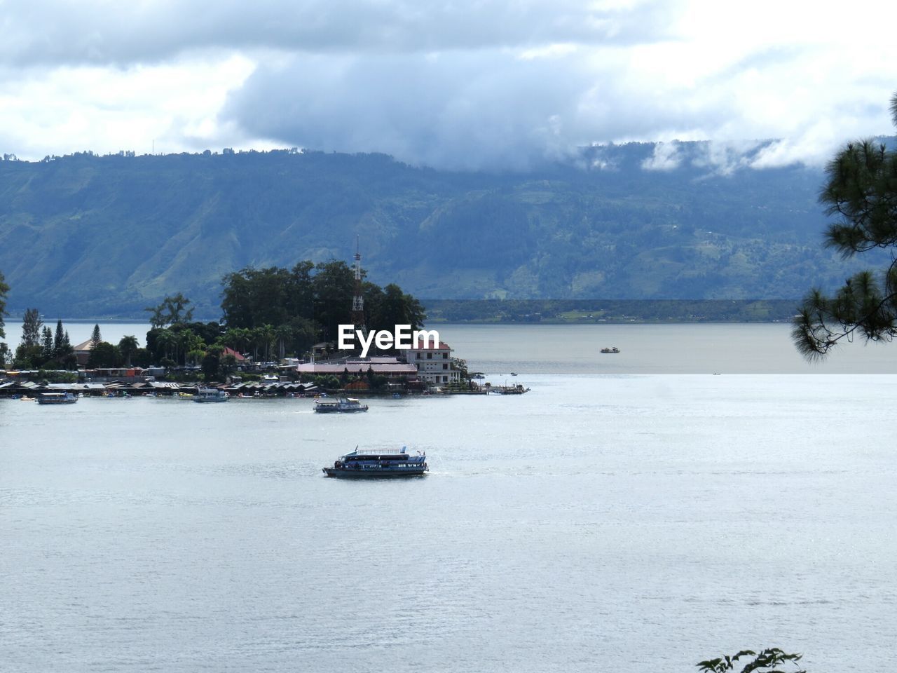 High angle view of boats at harbor with mountain in background